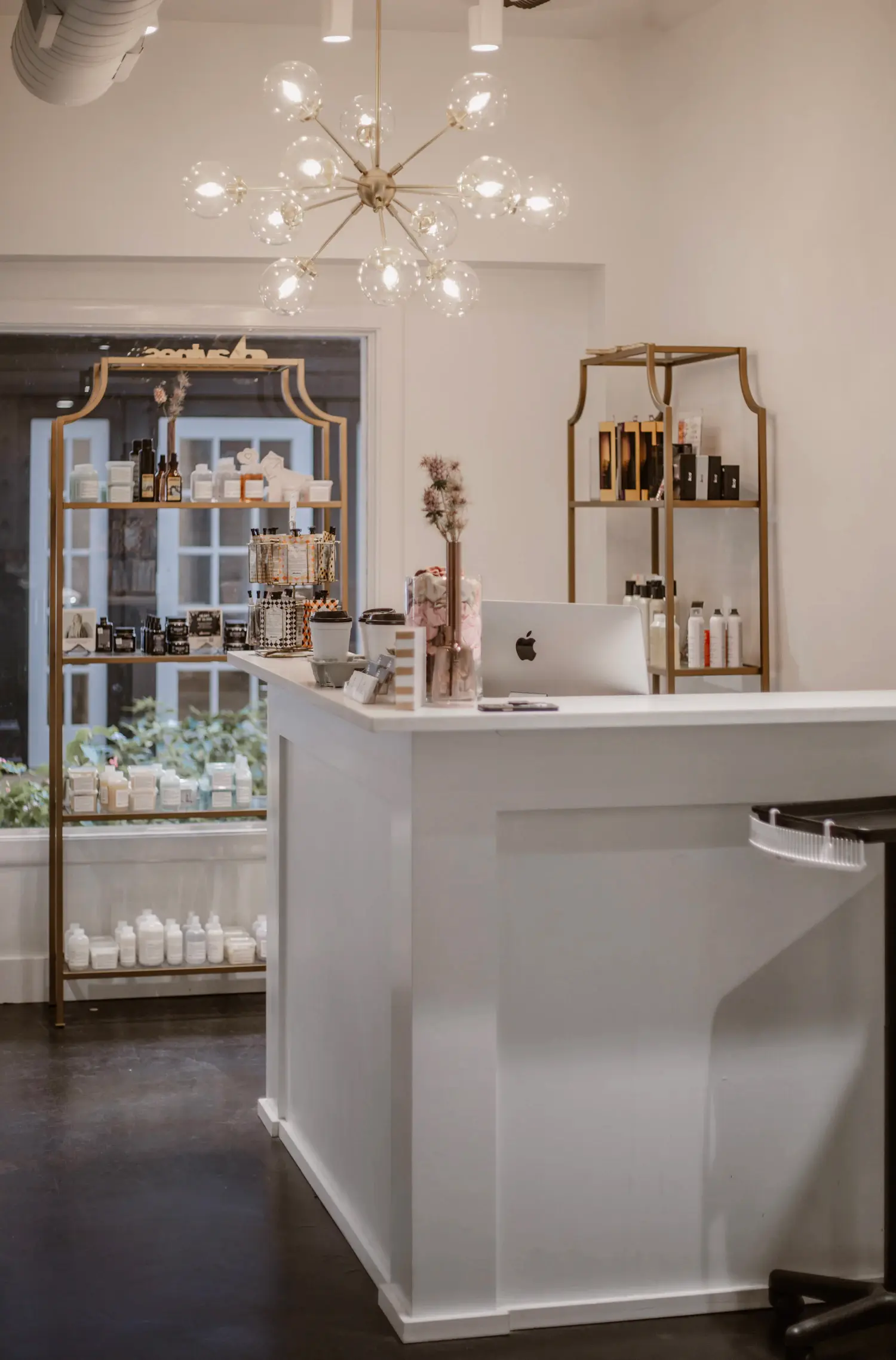 A bright salon reception with brass shelving